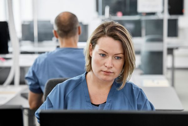 Medical staff facing the viewer looking at computer screen